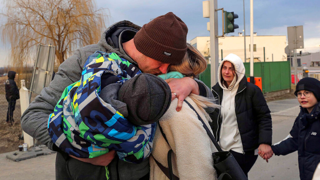 A Ukrainian family is reunited after arriving at the Medyka border crossing, Poland, Saturday, Feb. 26, 2022.