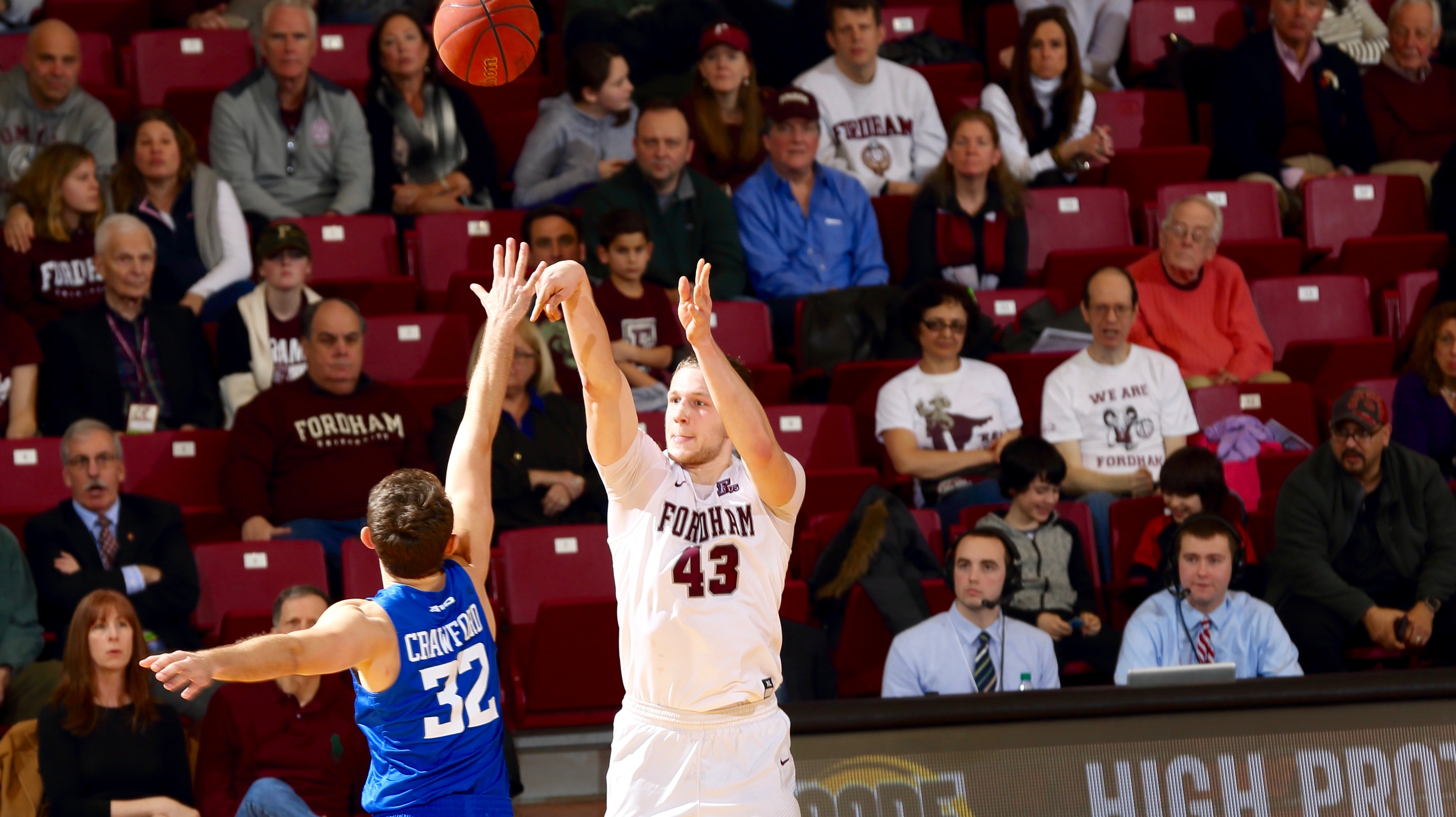 WFUV broadcasters look as Christian Sengfelder goes up for jumper.