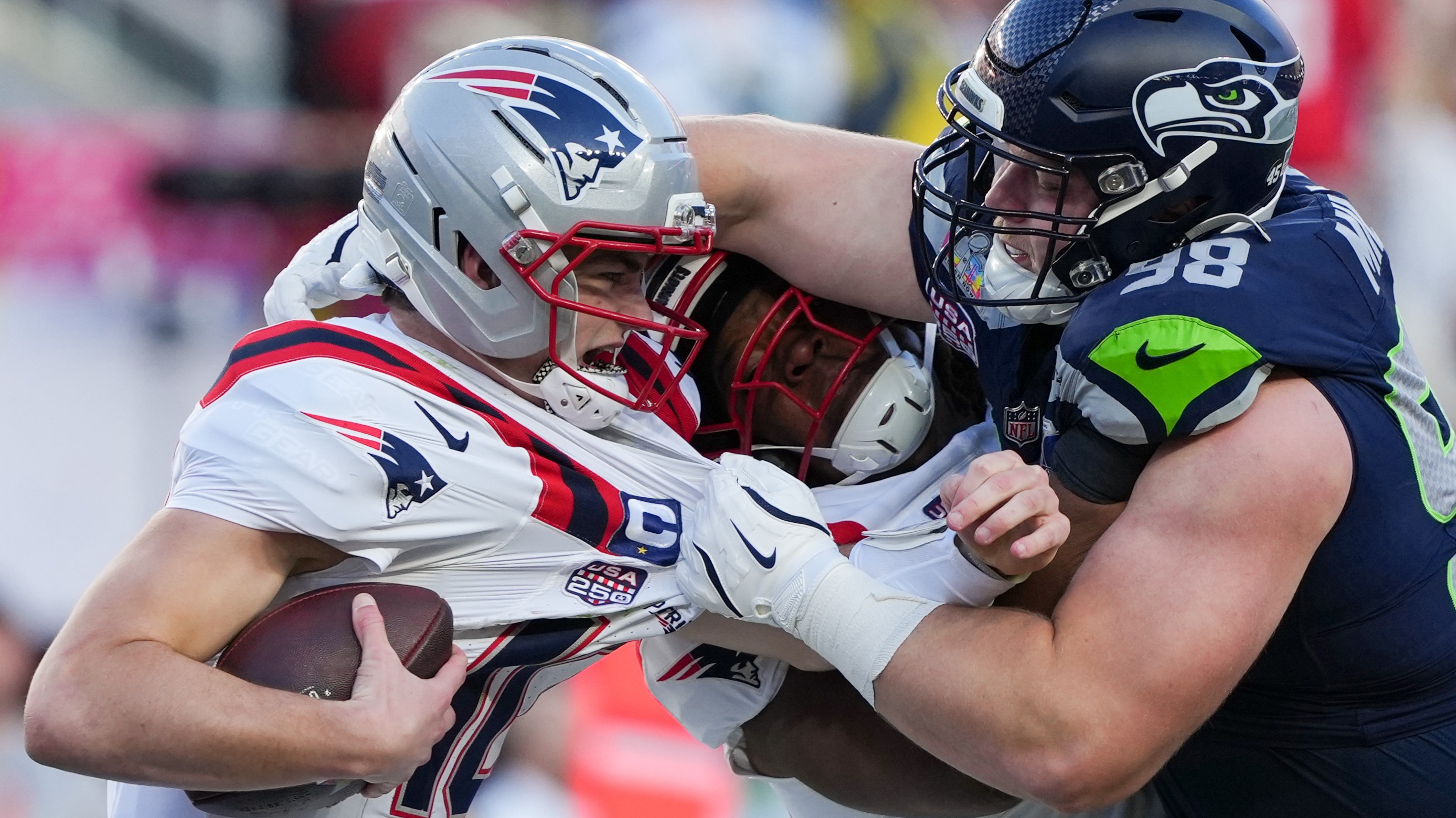 Seattle Seahawks defensive end Rylie Mills, right, sacks New England Patriots quarterback Drake Maye, left, during the first half of the NFL Super Bowl 60 football game, Sunday, Feb. 8, 2026, in Santa Clara, Calif.