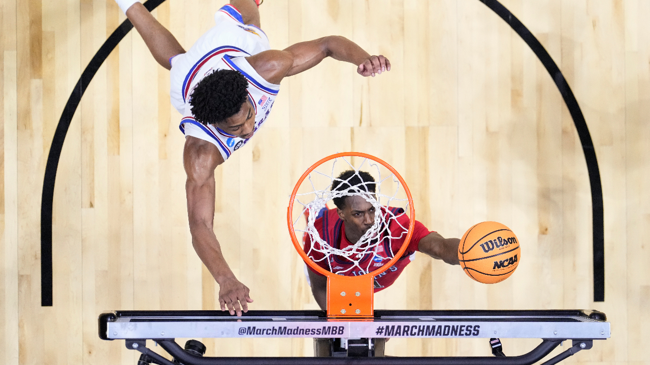 St. John's guard Ian Jackson shoots around Kansas forward Bryson Tiller during a game in the second round of the NCAA college basketball tournament Sunday, March 22, 2026, in San Diego.