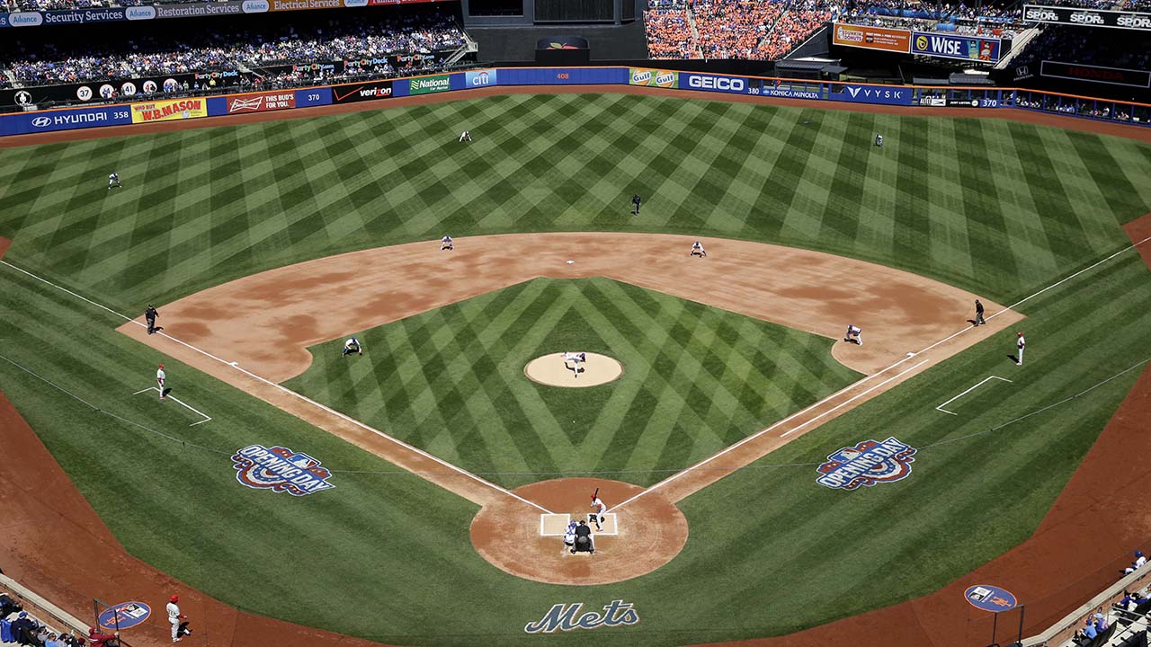 New York Mets starting pitcher Jacob deGrom, center, throws the first pitch of the baseball game against the Philadelphia Phillies at Citi Field, Monday, April 13, 2015 in New York. (AP Photo/Seth Wenig)