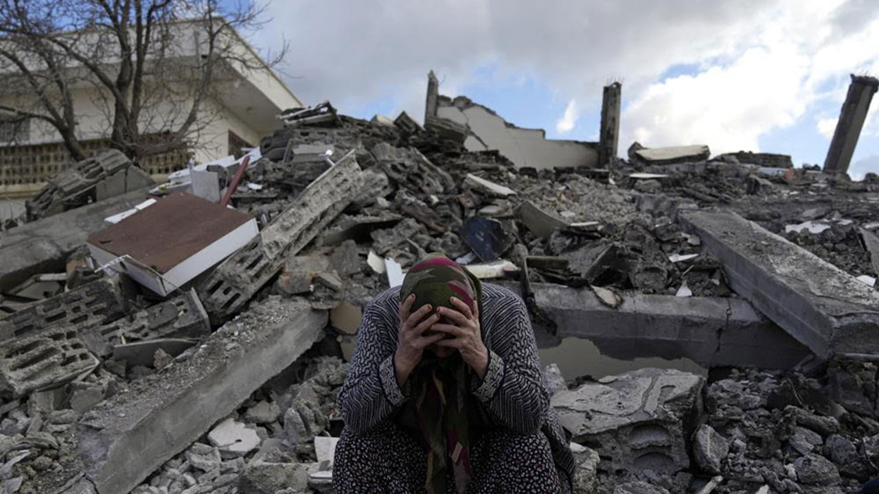 A woman sits on the rubble as emergency rescue teams search for people under the remains of destroyed buildings in Nurdagi town on the outskirts of Osmaniye city in southern Turkey. (AP Photo/Khalil Hamra) A woman sits on the rubble as emergency rescue teams search for people under the remains of destroyed buildings in Nurdagi town on the outskirts of Osmaniye city in southern Turkey. (AP Photo/Khalil Hamra)