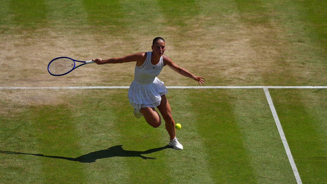 Marta Kostyuk of Ukraine returns the ball to Jasmine Paolini of Italy in their quarter-final women's singles match at the Wimbledon Tennis Championships in London, Wednesday, July 8, 2026.