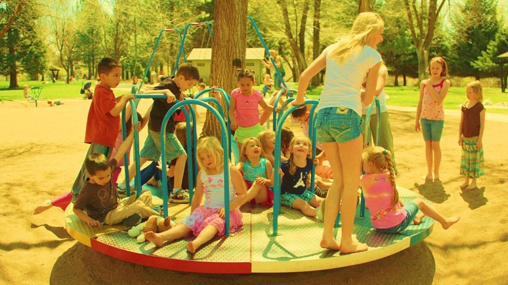 children playing on a merry-go-round