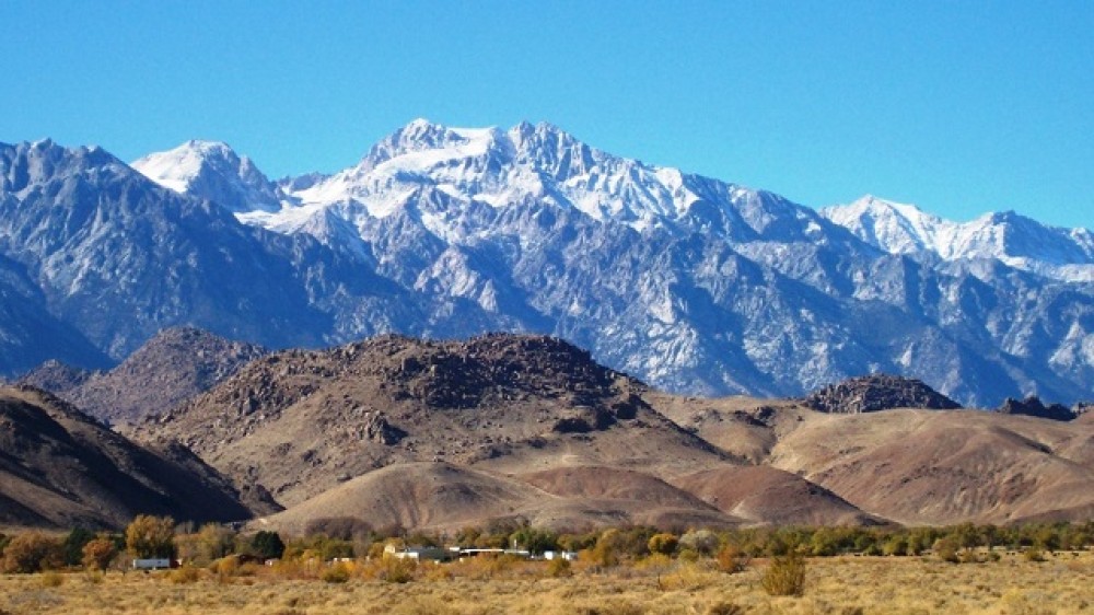 Low-lying Alabama Hills in front of the snow-capped eastern Sierra Mountains near Lone Pine, CA