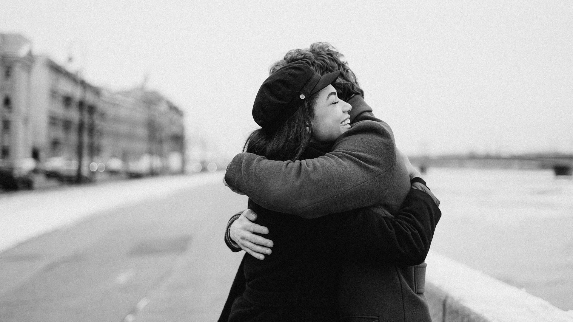 a man and a woman hugging outdoors