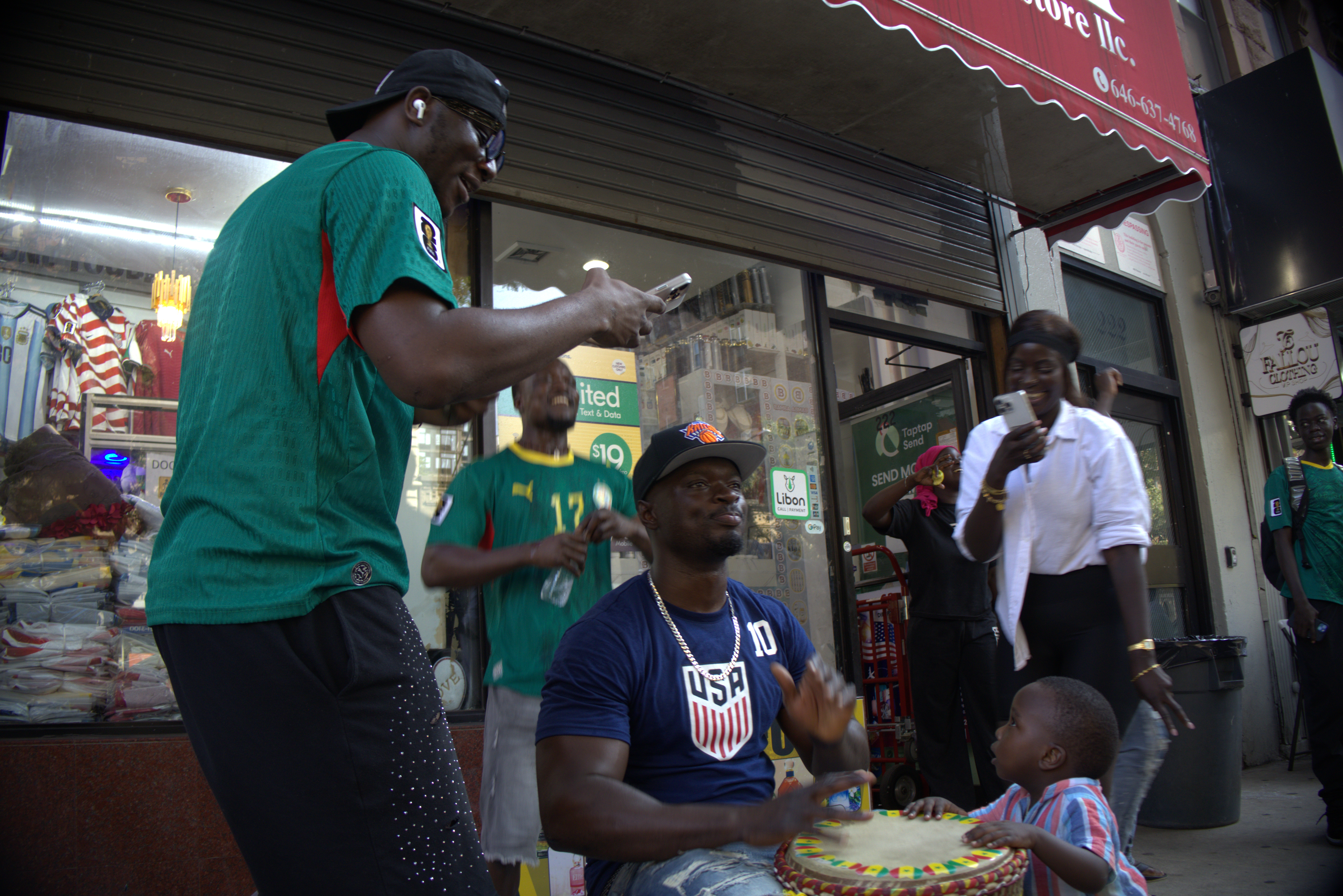Photo of Arnaud Mendy playing drums to celebrate Senegal’s goal against Belgium by Gabriel Capellan