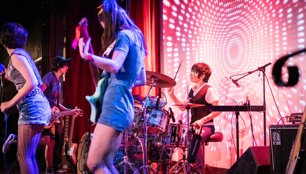 Milo Miller (center) playing the drums for Kids Rock for Kids.